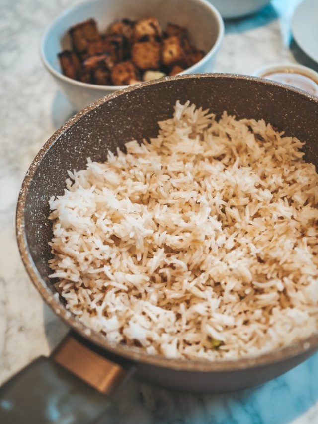 Garlic basmati rice in a pan and tofu in a bowl in the backgrounds..