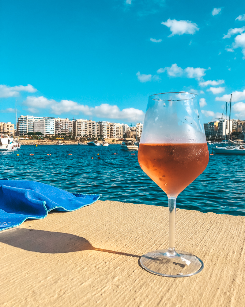 Glass of rose wine by the sea