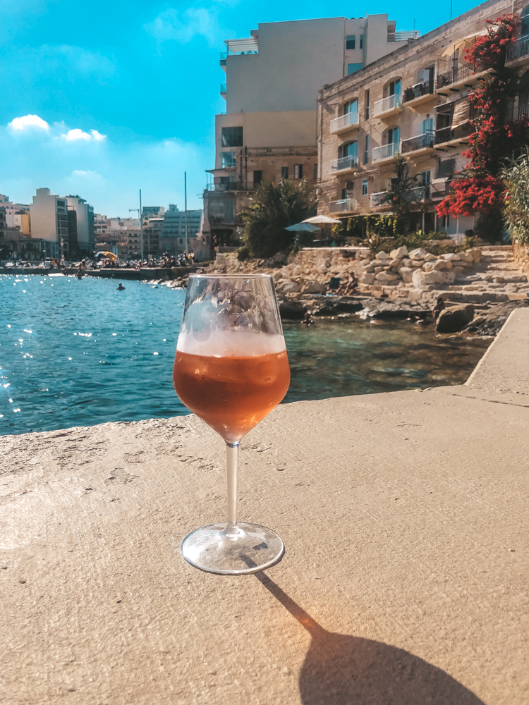 Glass of rose wine by the sea