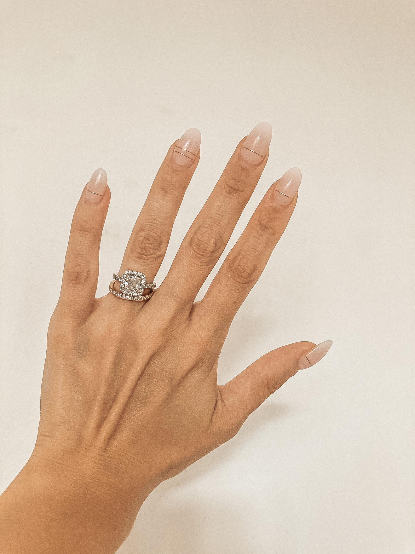 Hand with a white French ombre manicure - a manicure that matches every outfit