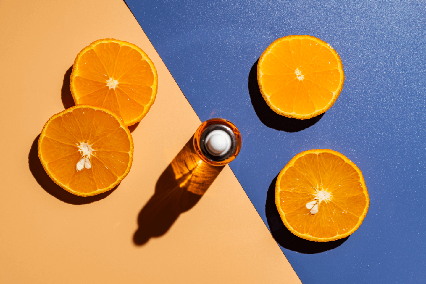 Vitamin C serum surrounded by sliced oranges