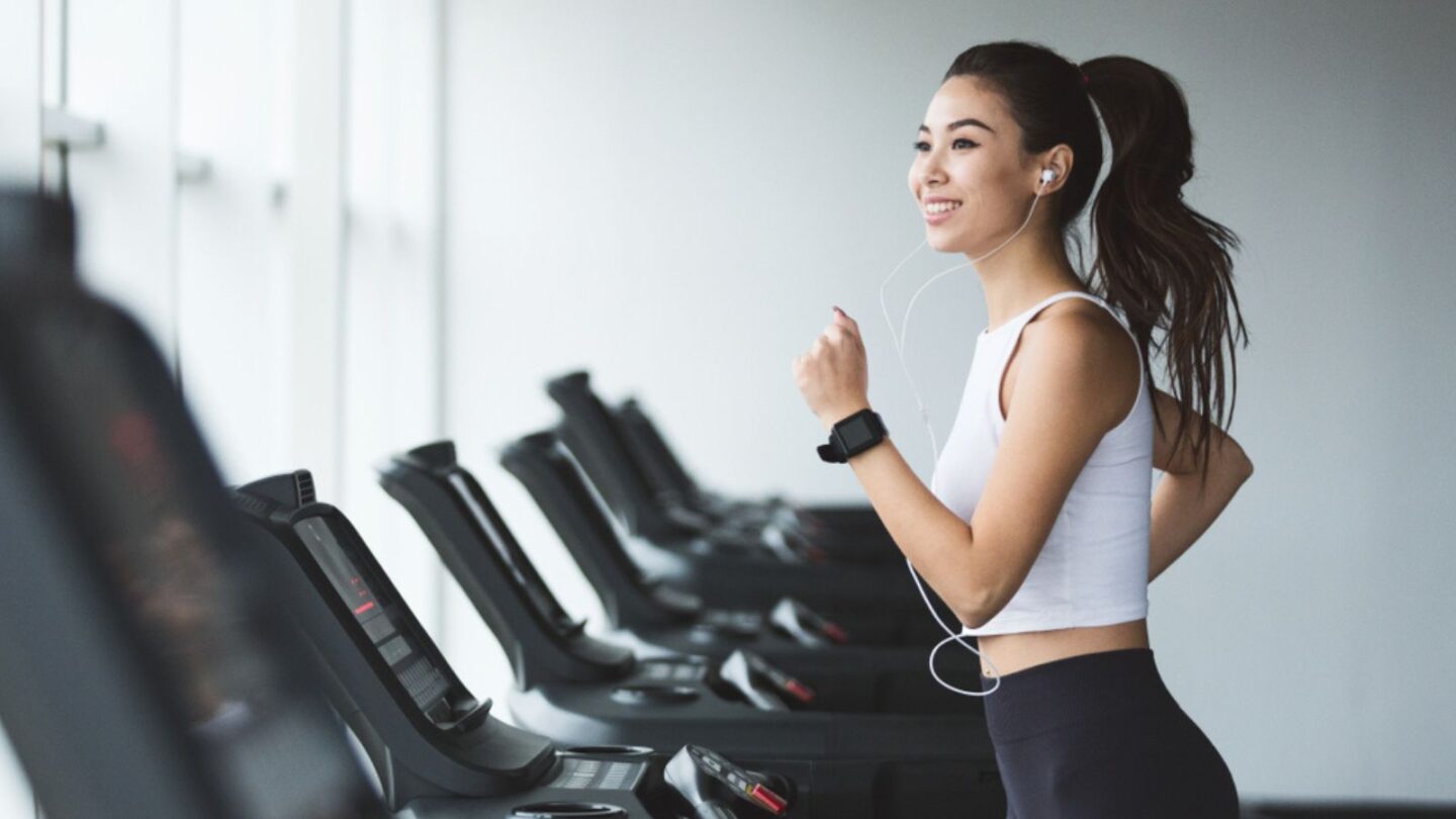 Asian-woman-running-on-treadmill-at-the-gym