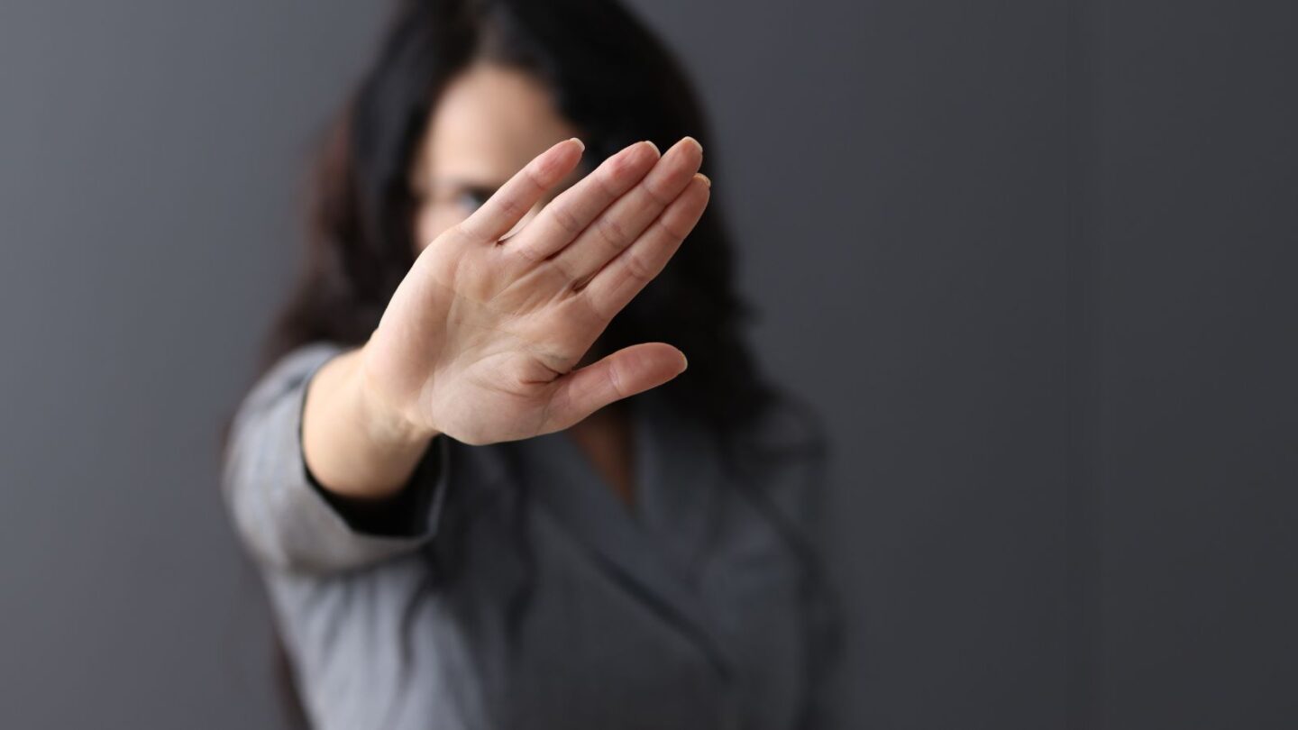 Woman putting up her hand, symbolic of blocking unnecessary vices