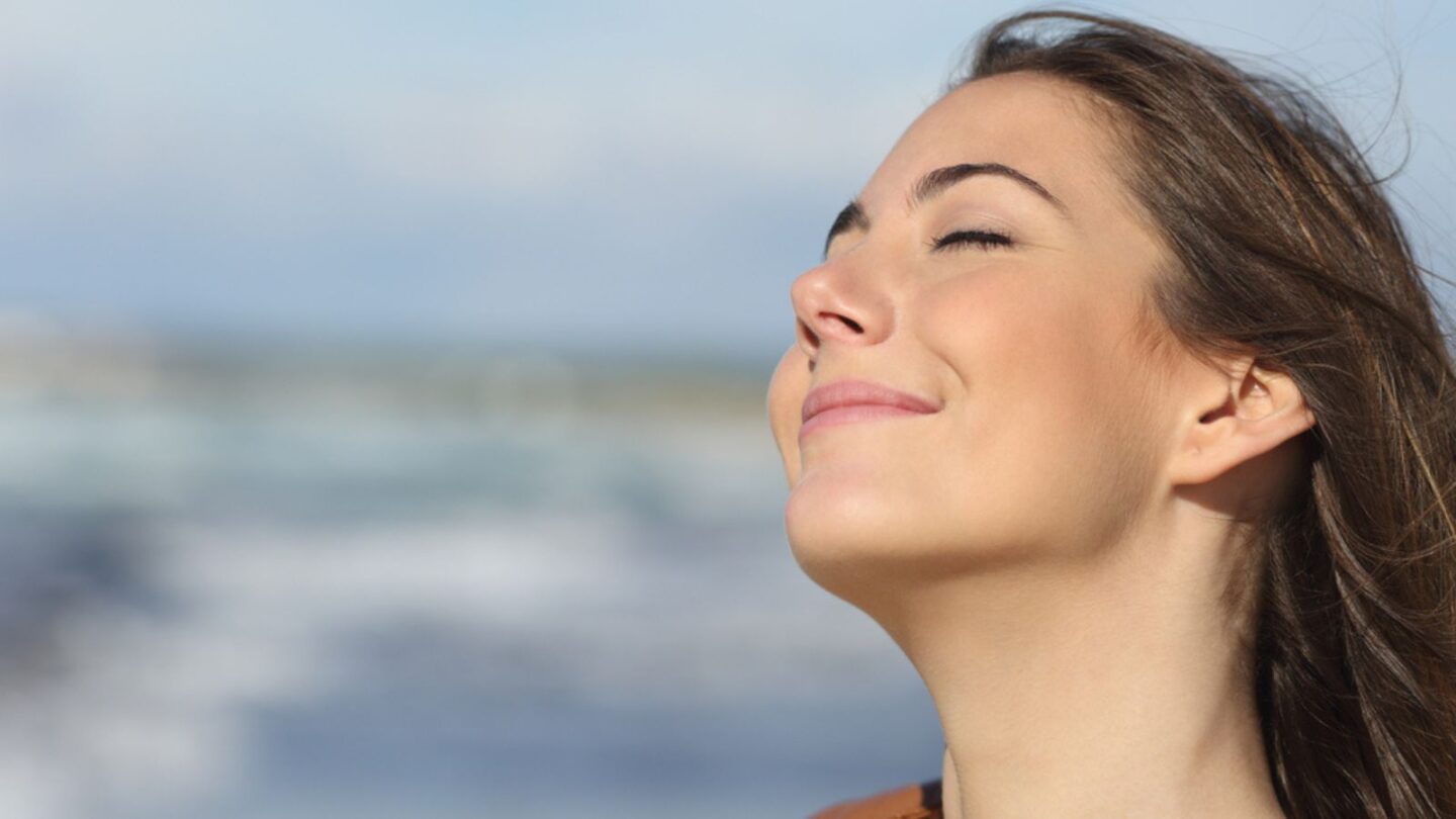 Woman breathing in and meditating