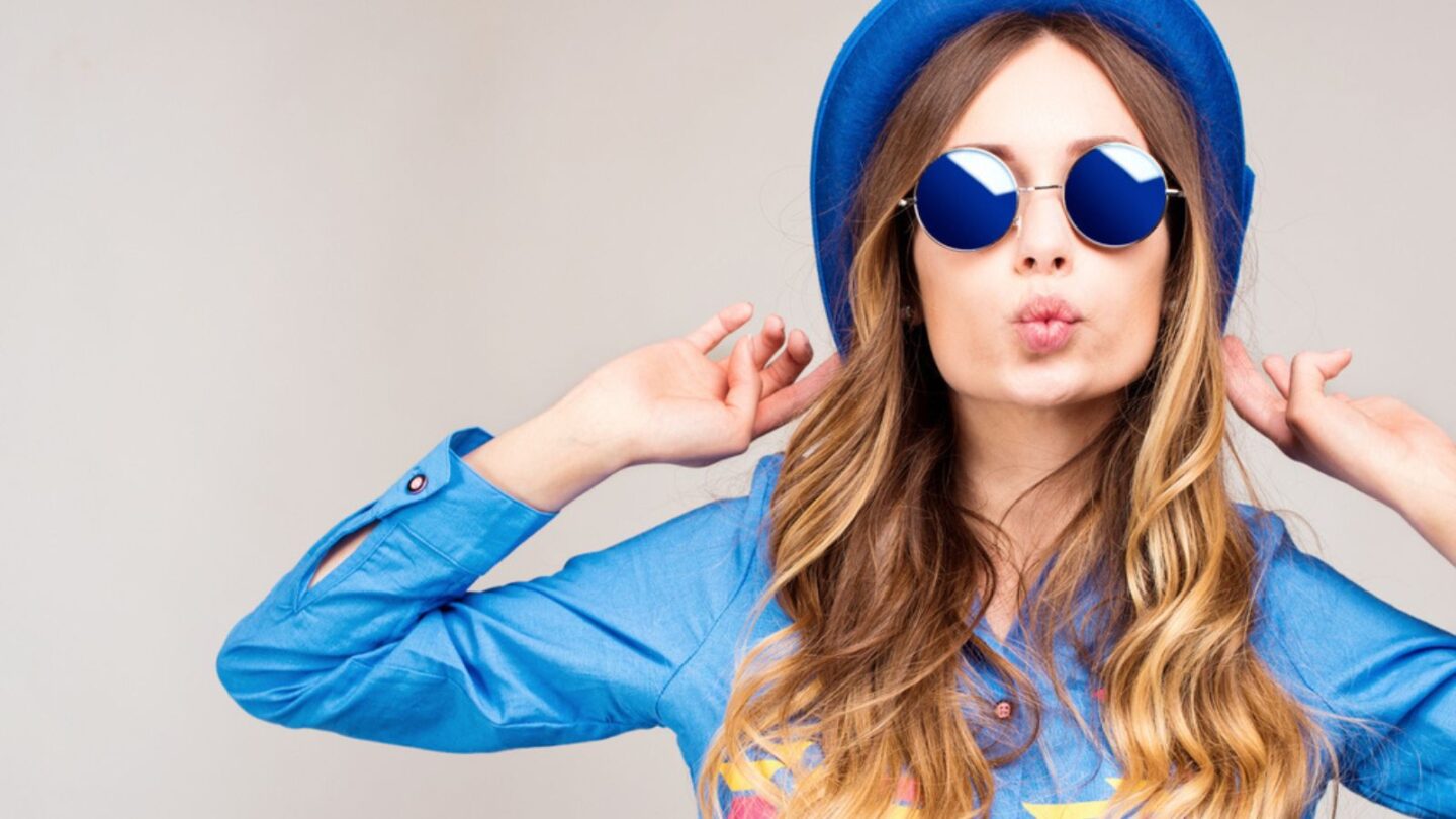 Trendy woman wearing blue sunglasses