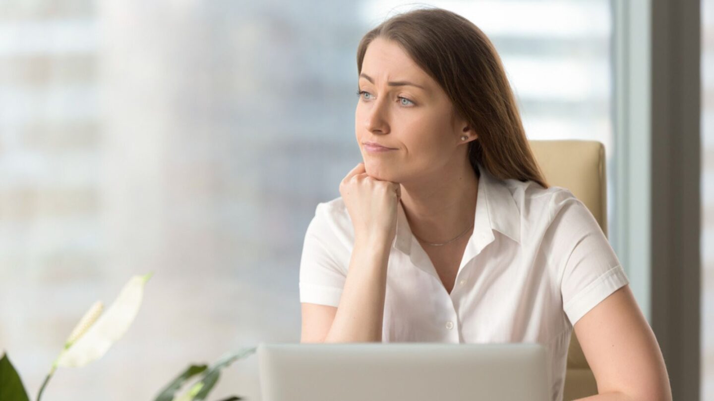 Sad woman sitting at desk job