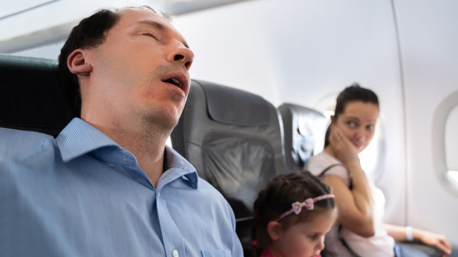 Woman annoyed at man snoring
