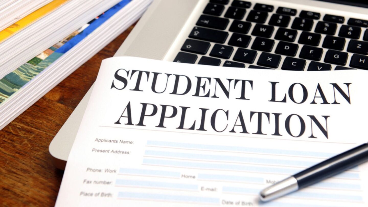 blank student loan application on desktop with books and laptop