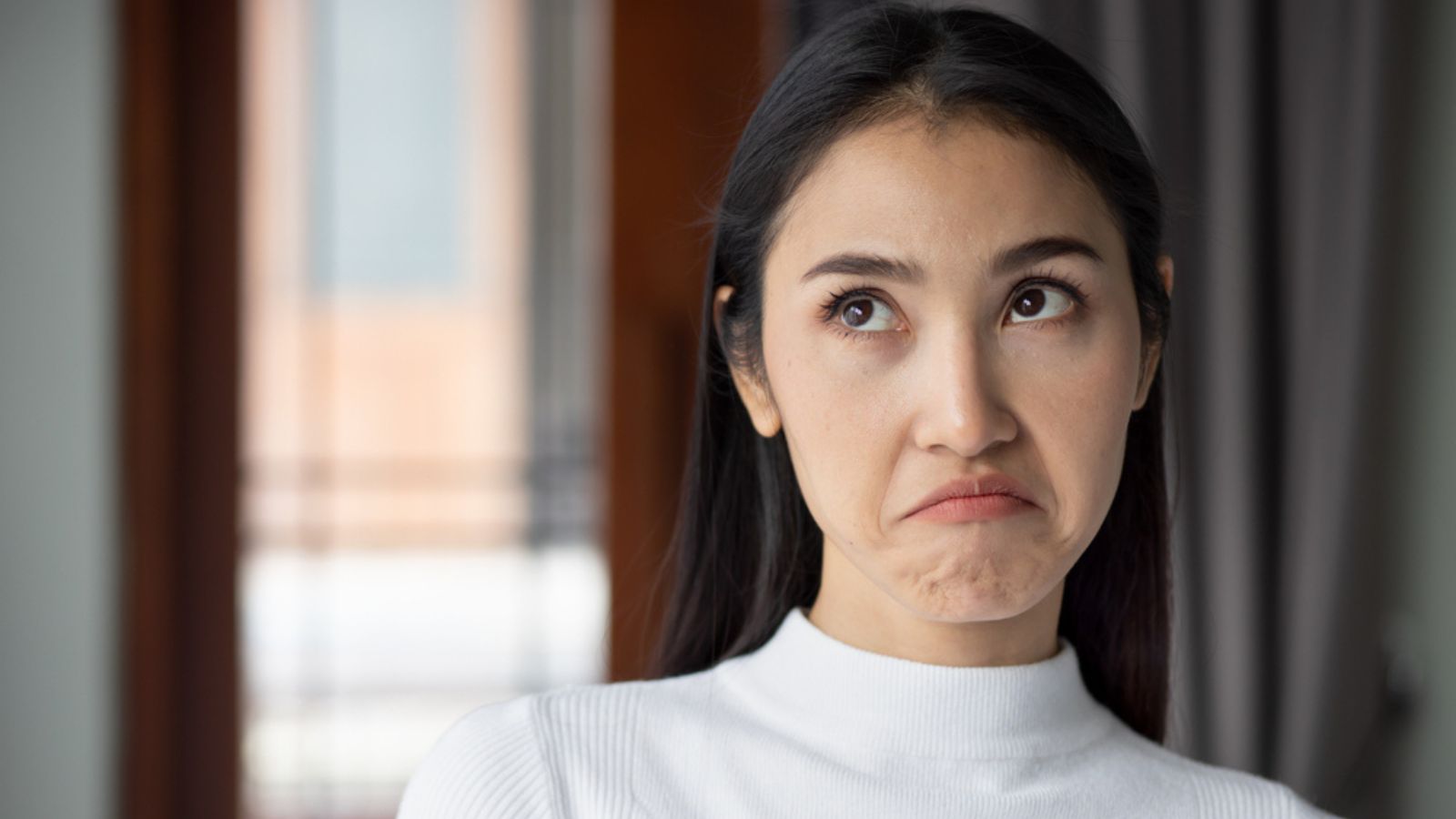 upset unhappy woman rolling her eye
